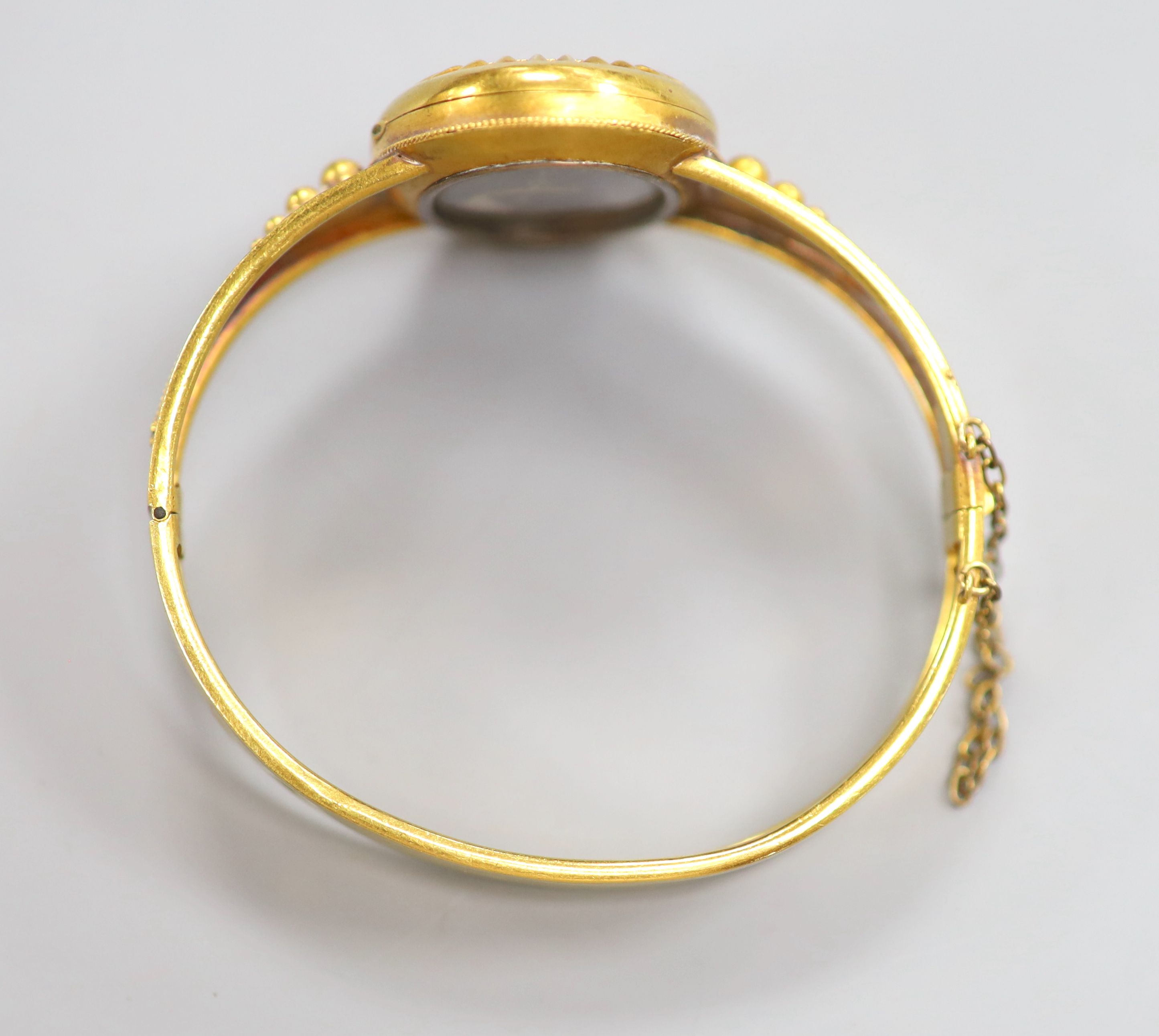 A Victorian yellow metal, blue enamel and split pearl set hinged mourning bangle(a.f.) gross 19.1 grams,